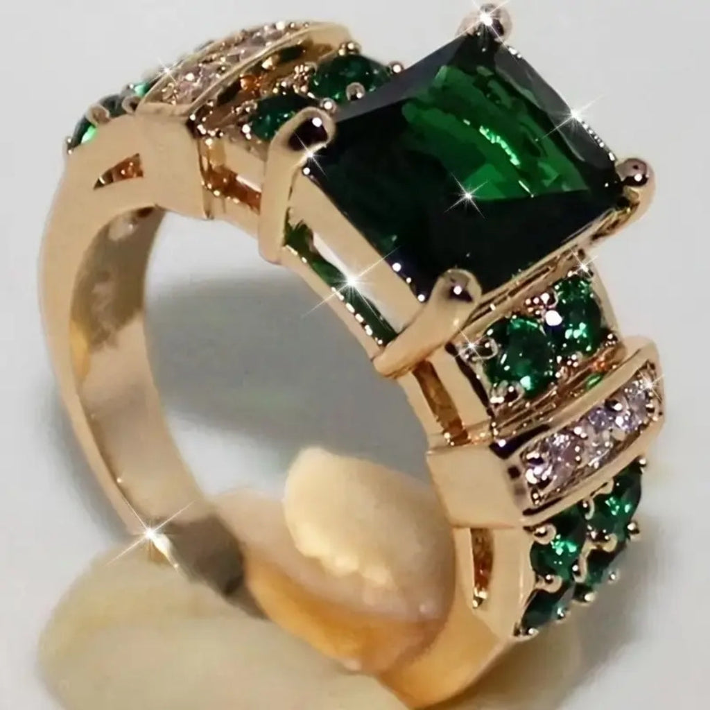 Anillo dorado con cristal verde
